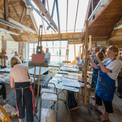 A group of students painting during an art course